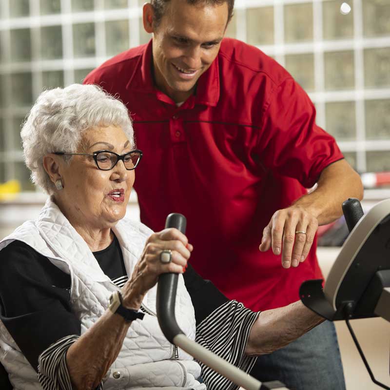 Elderly woman training with her coach