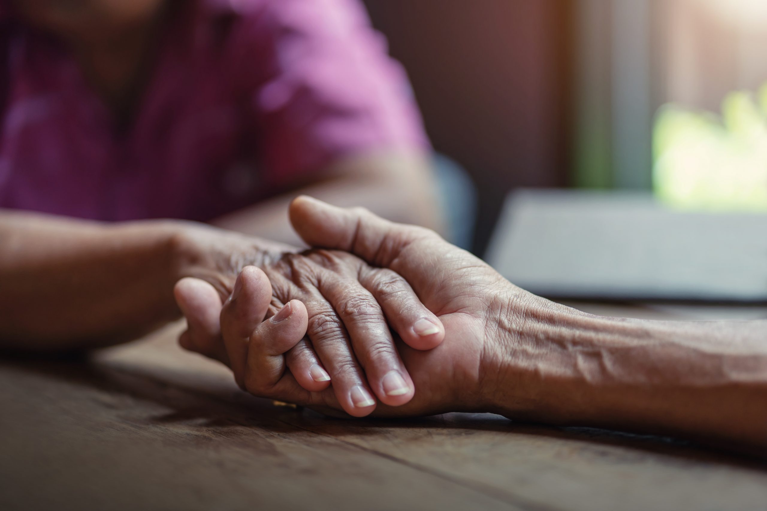 elderly residents holding hands